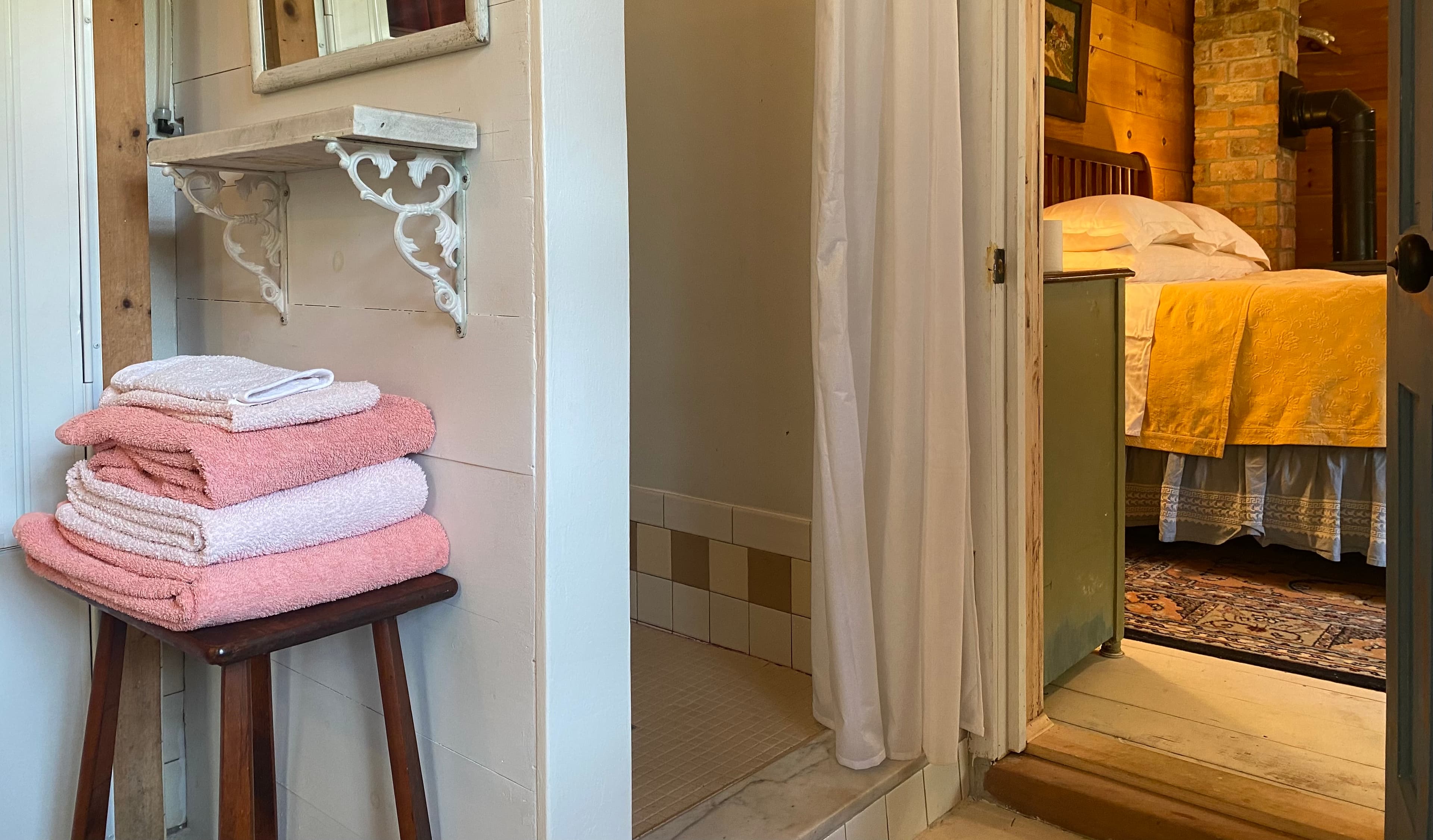 Glimpse of a cozy bedroom thru a shower with partially visible shower with a yellow gingham shower curtain