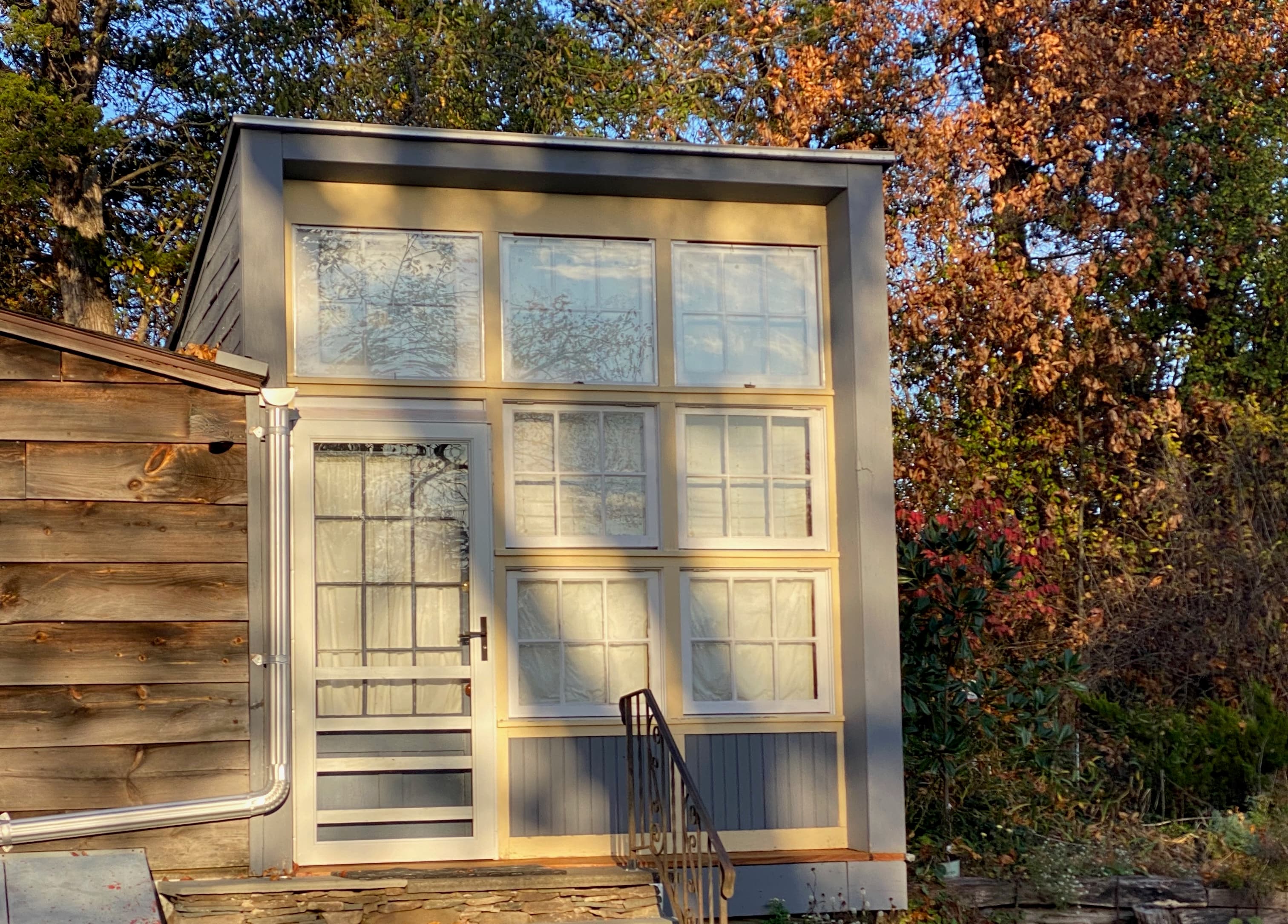 bedroom setting with double bed, a sink and rustic vanity and a green carpet