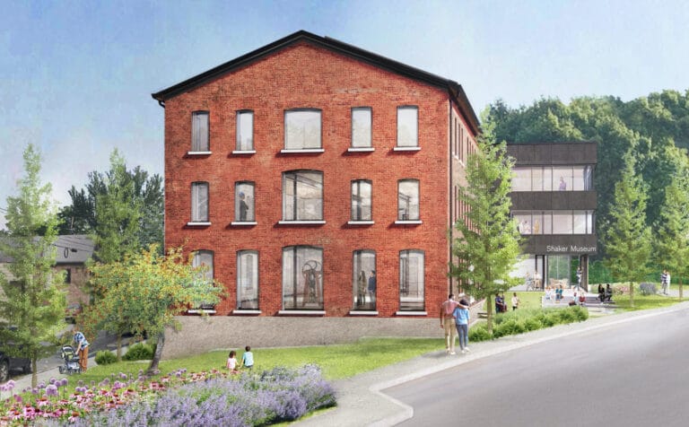 Exterior view of the Shaker Museum. A 3 story solid brick building set on beautifully landscaped lawns and gardens.